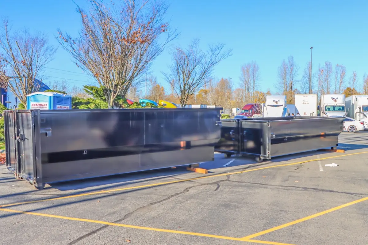 Professional dumpster rental service with roll-off container on residential driveway in Schroeppel